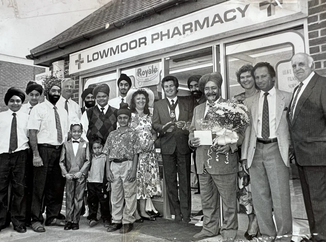 A group gathered outside the original Lowmoor Pharmacy